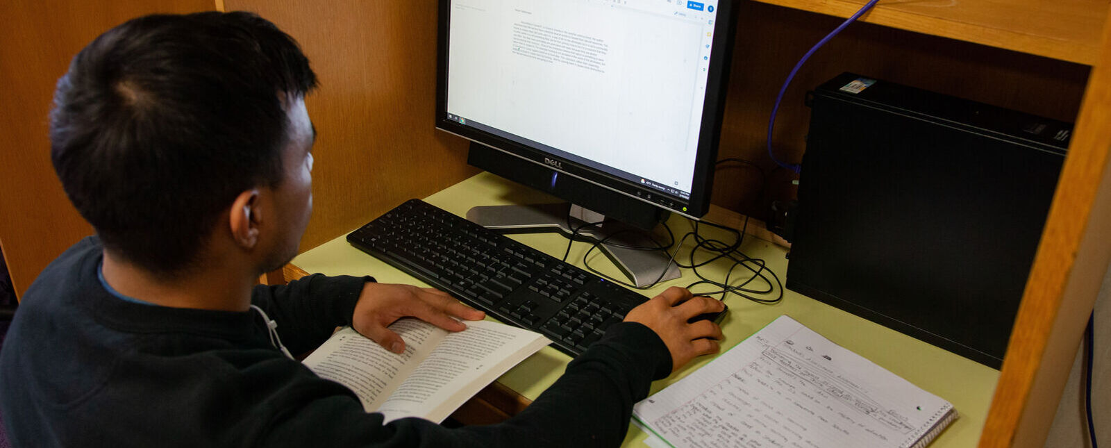 A male student works at a computer