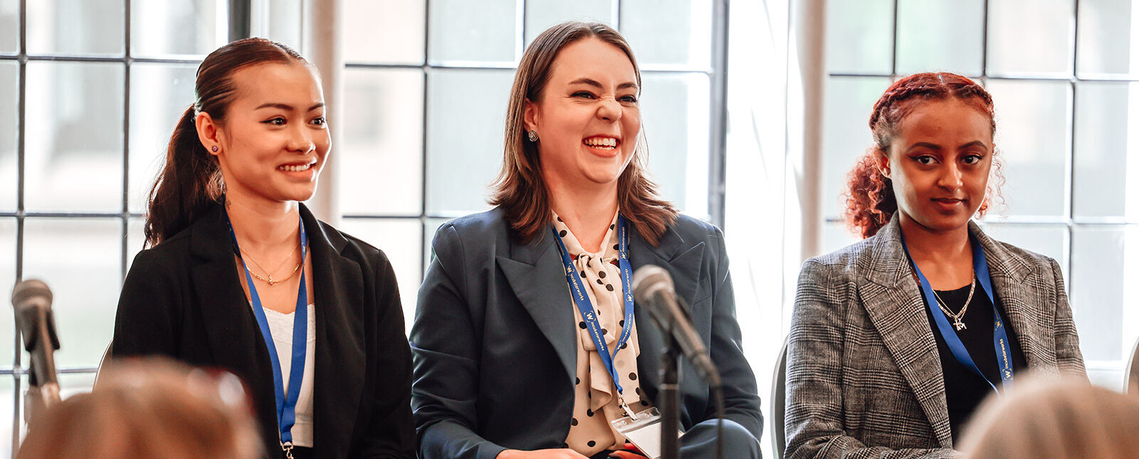 A team of female students is pictured while making a business pitch during a competition