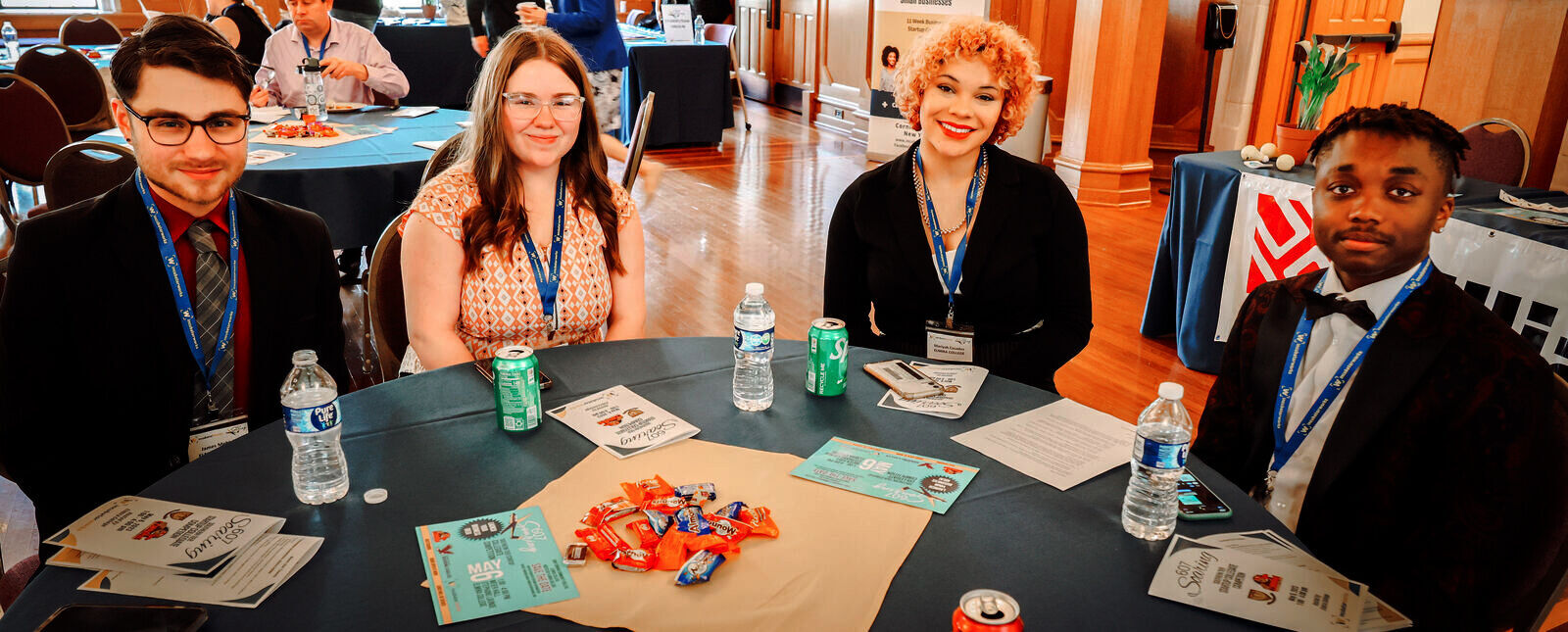 A 607 Soaring pitch team sits around a table in Stephans Lounge during competition