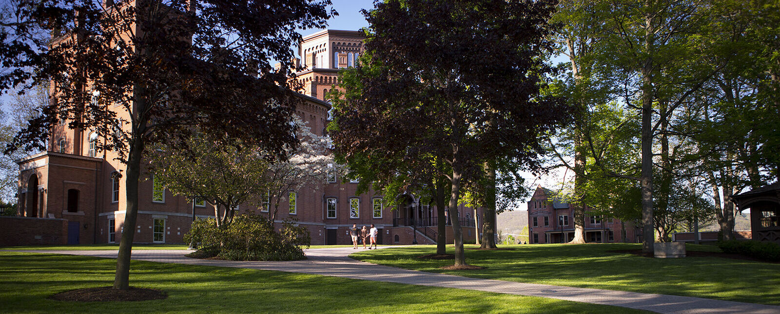 Cowles Hall sits among trees on campus