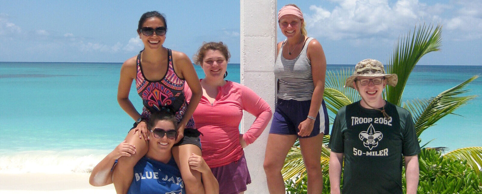 Students pose together on a beach in the Bahamas