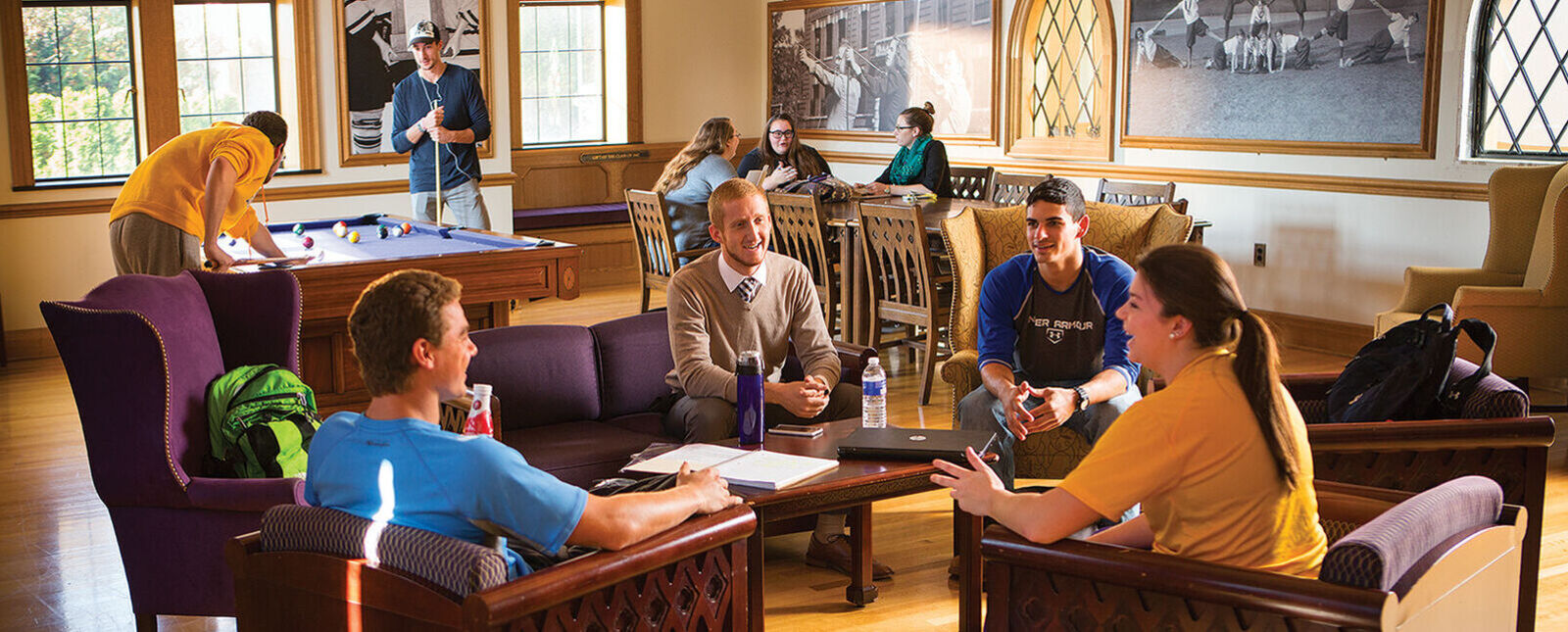 Groups of students hang out and play pool in Basal Lounge. 