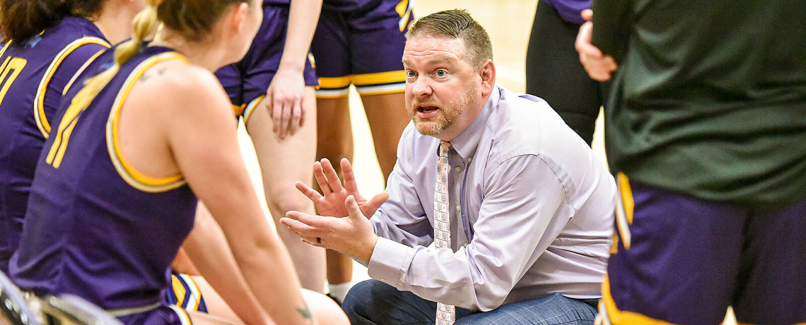 The women's basketball coach gives a pep talk to his team 