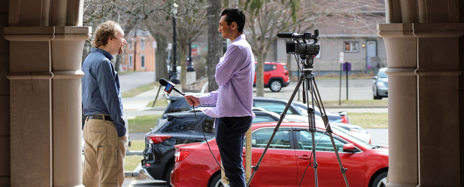 A TV news reporter interviews an Elmira College professor about the Climate Teach-In
