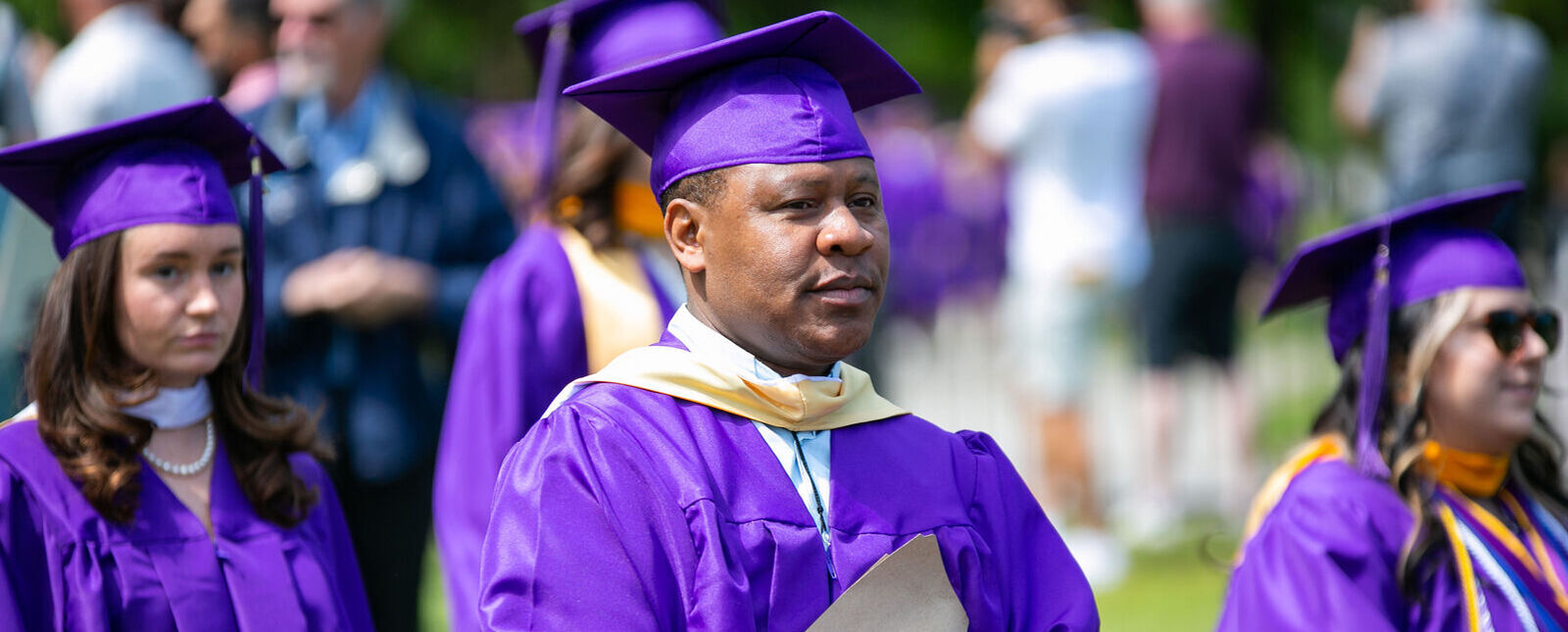 Graduates make their way forward during Commencement