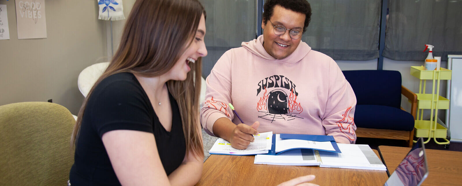 A female and male student work together in the tutoring center