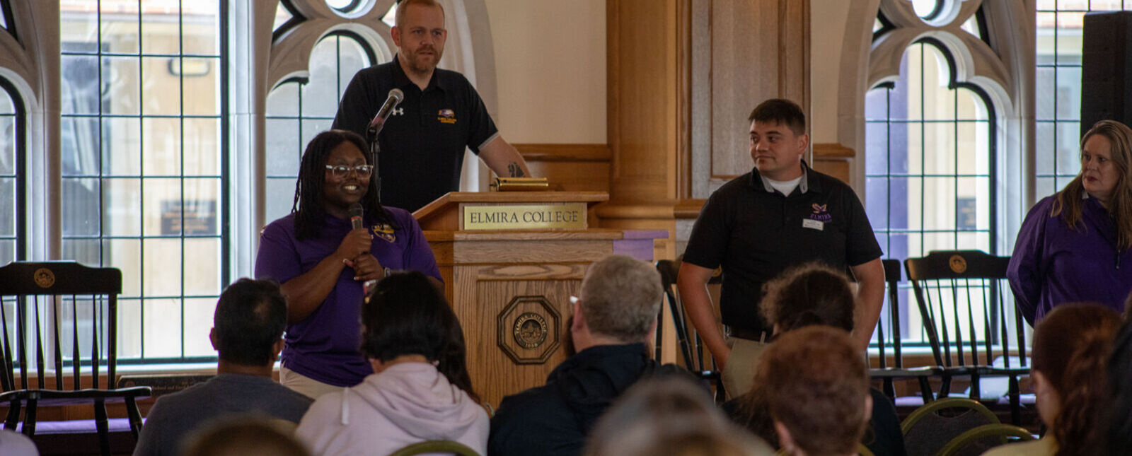 Admissions counselors stand in front of a seated audience in Stephans Lounge. 