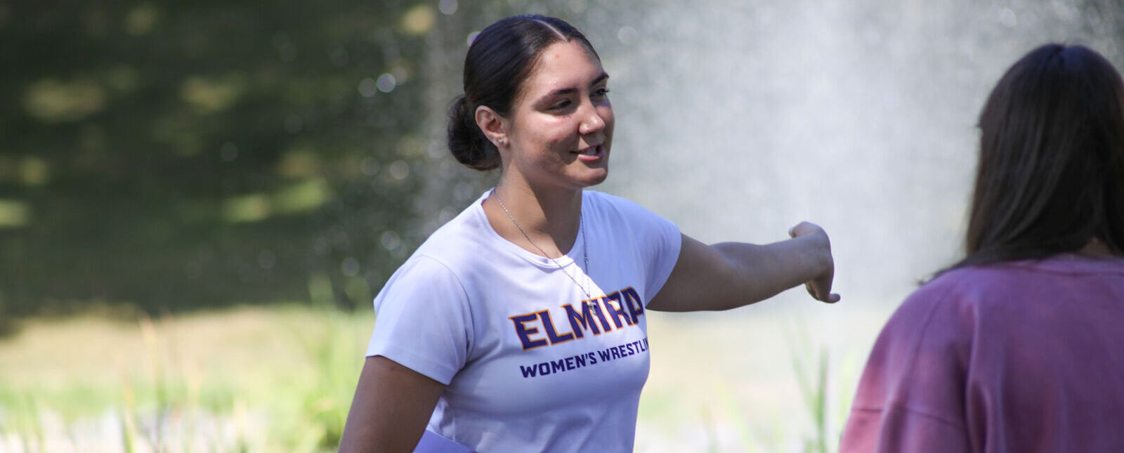 A student leads a tour of the Elmira College campus