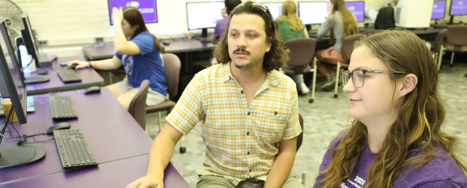 Dr. Trevor Browning and Jessica Yesensky '26 work together in a campus computer lab.