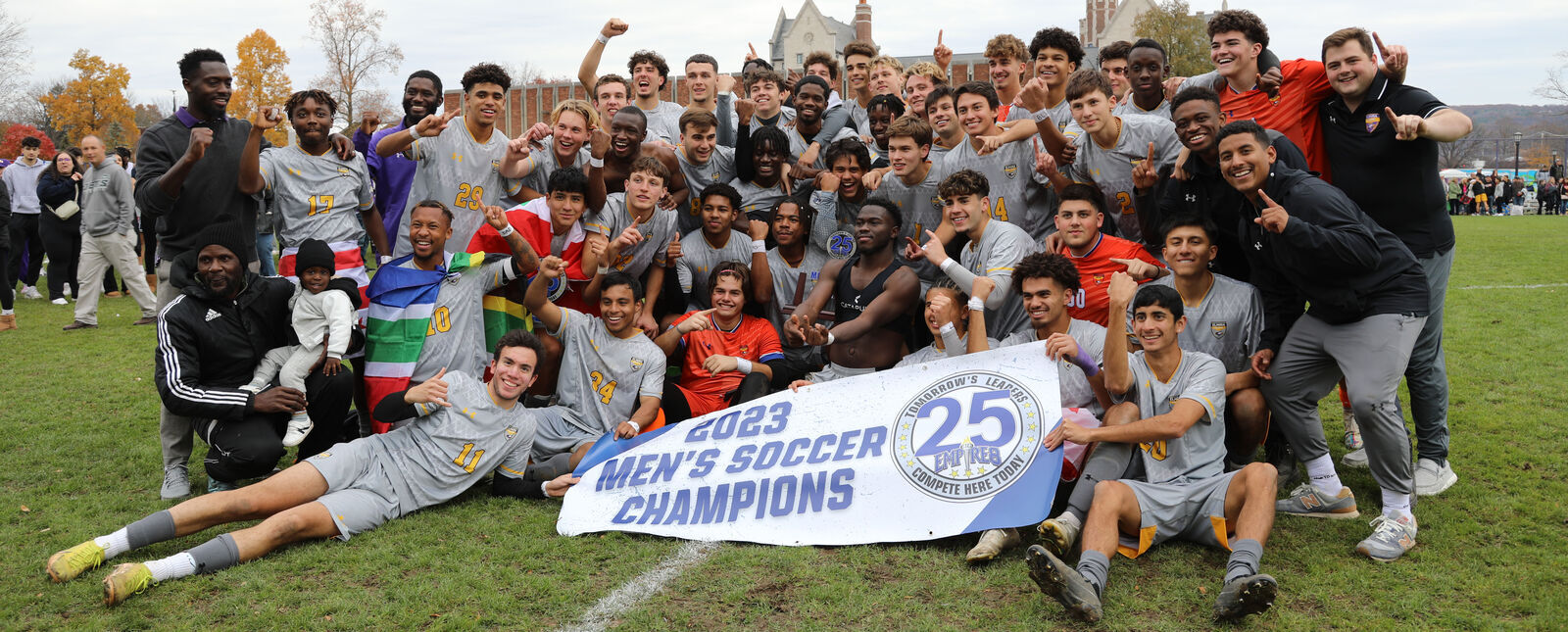 The Elmira College men's soccer team poses for a picture with a banner recognizing them as the Empire 8 champions