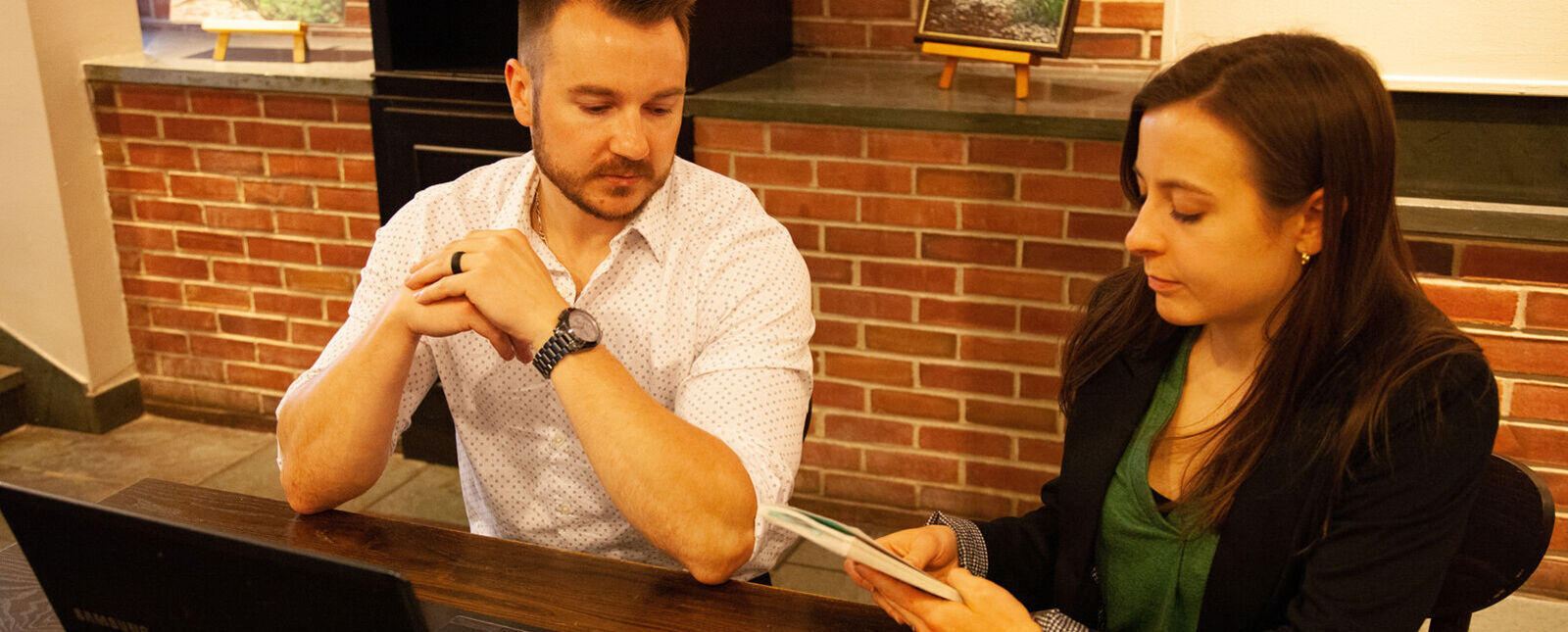 A male and female student work on an assignment together.