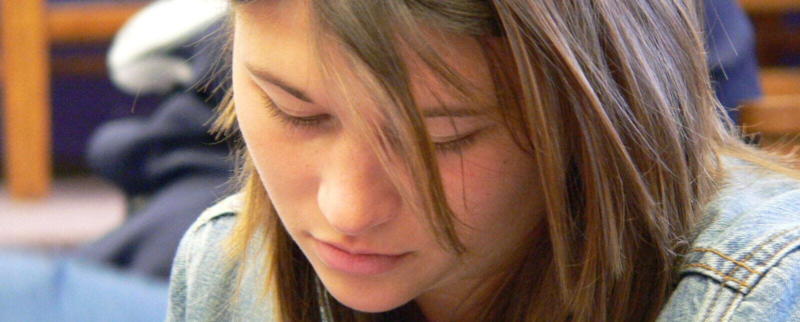 A female student focuses on work in a classroom