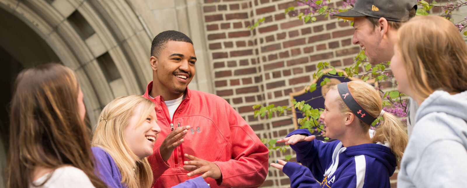 A group of student have fun talking outside