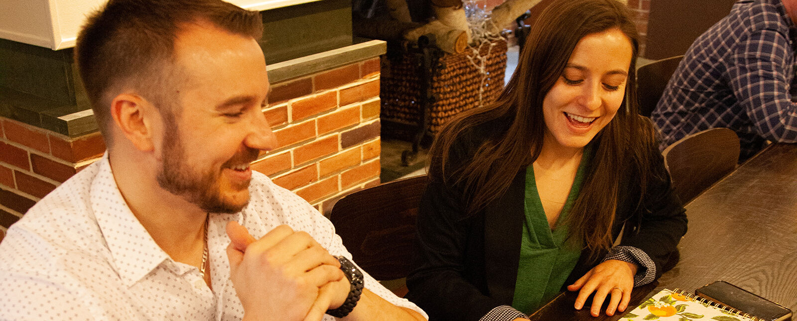 A male and female student smile as they work together.