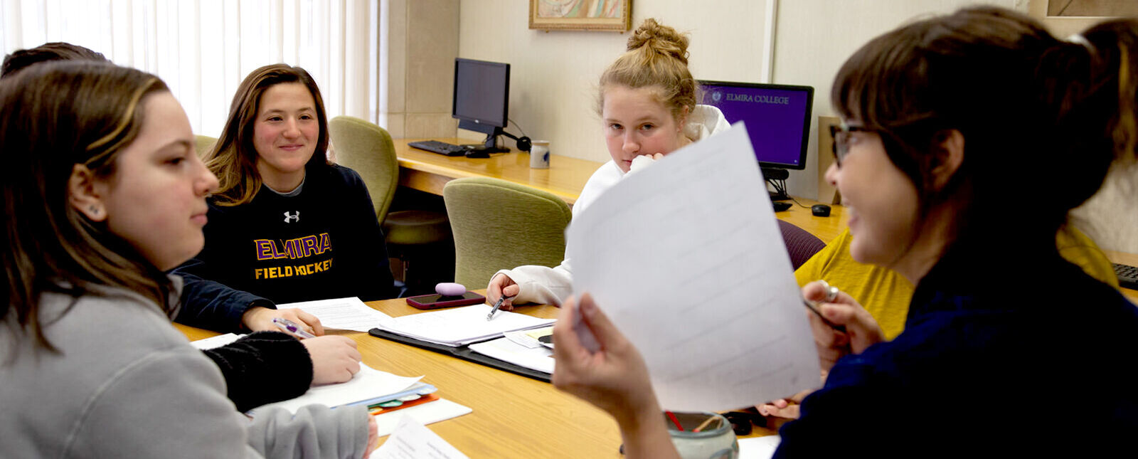 Students get help from a faculty member in the Writing Center