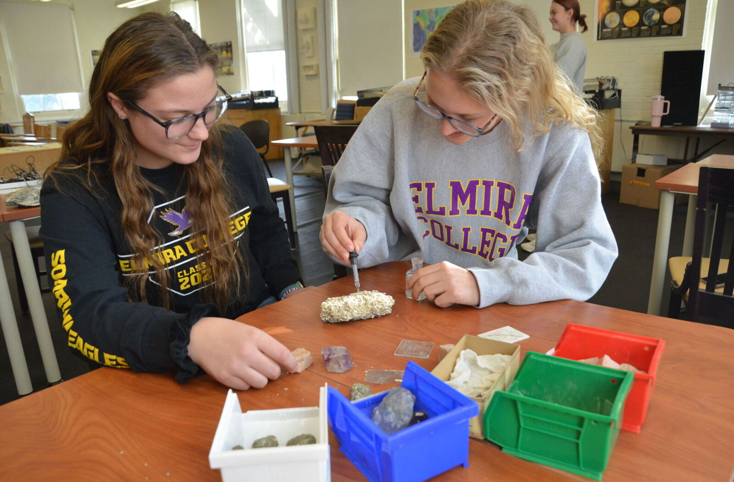 Two female students experiment with rocks in an Environmental Science class
