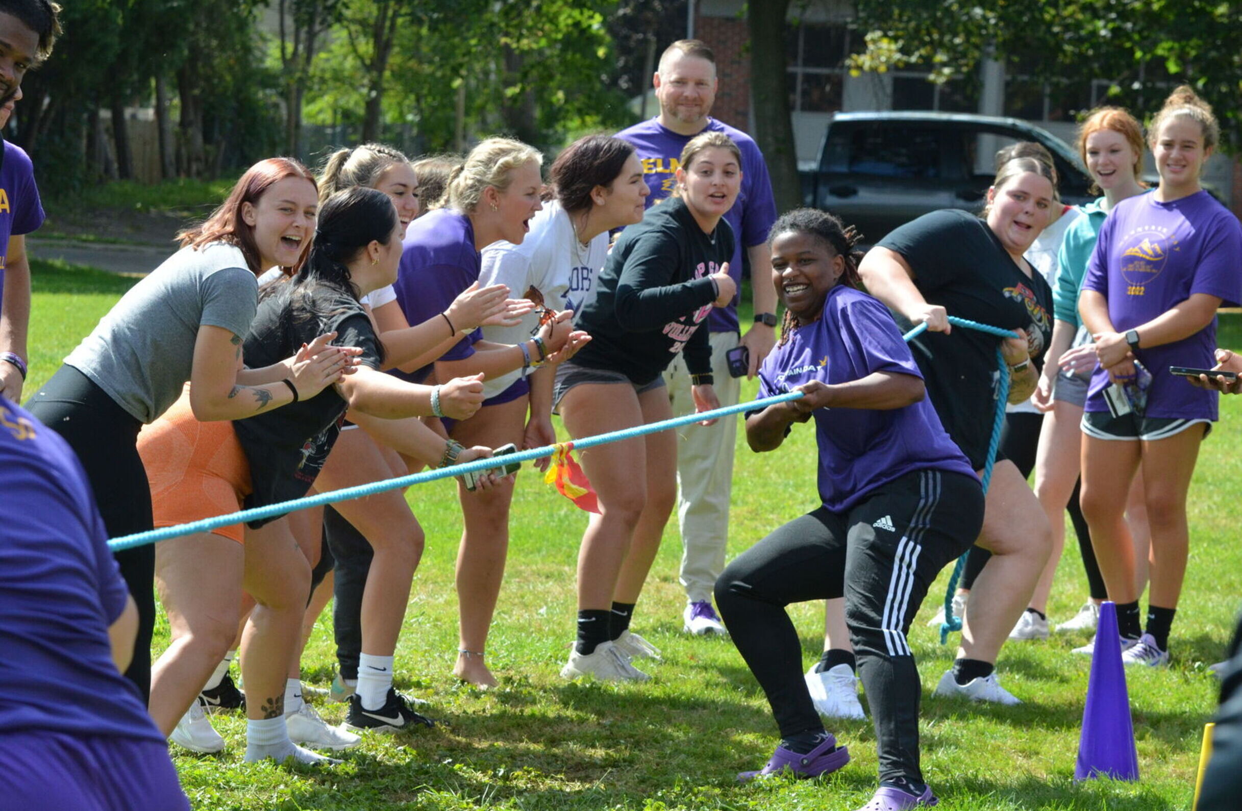 Students cheer on a team of two competing in tug-of-war