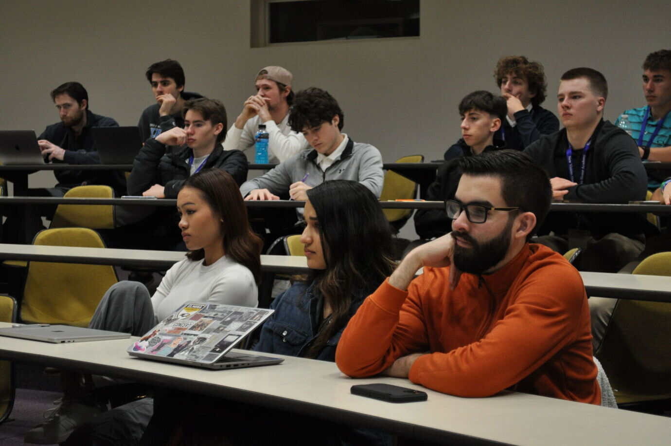Students listen to a presenter in a lecture hall