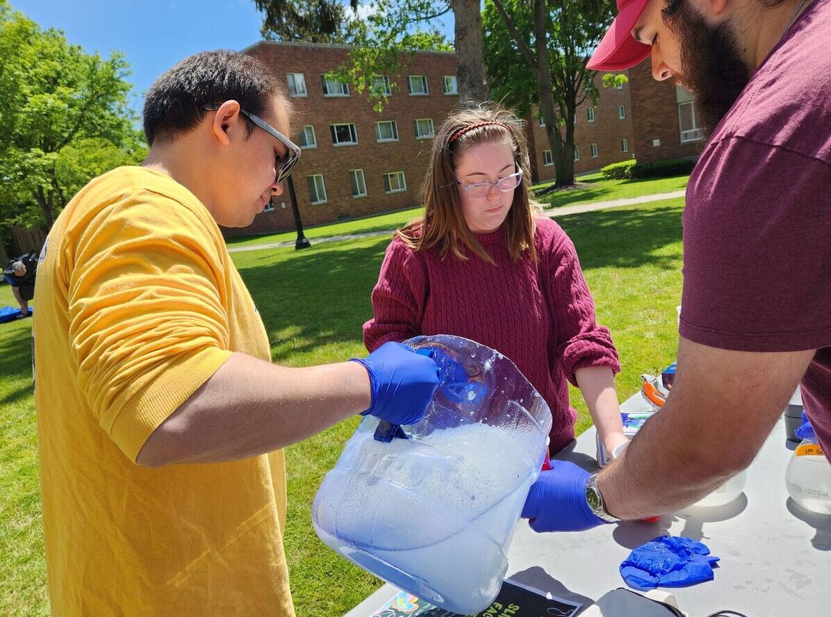 Chemistry Club members mix up slime during the Slime the Faculty event