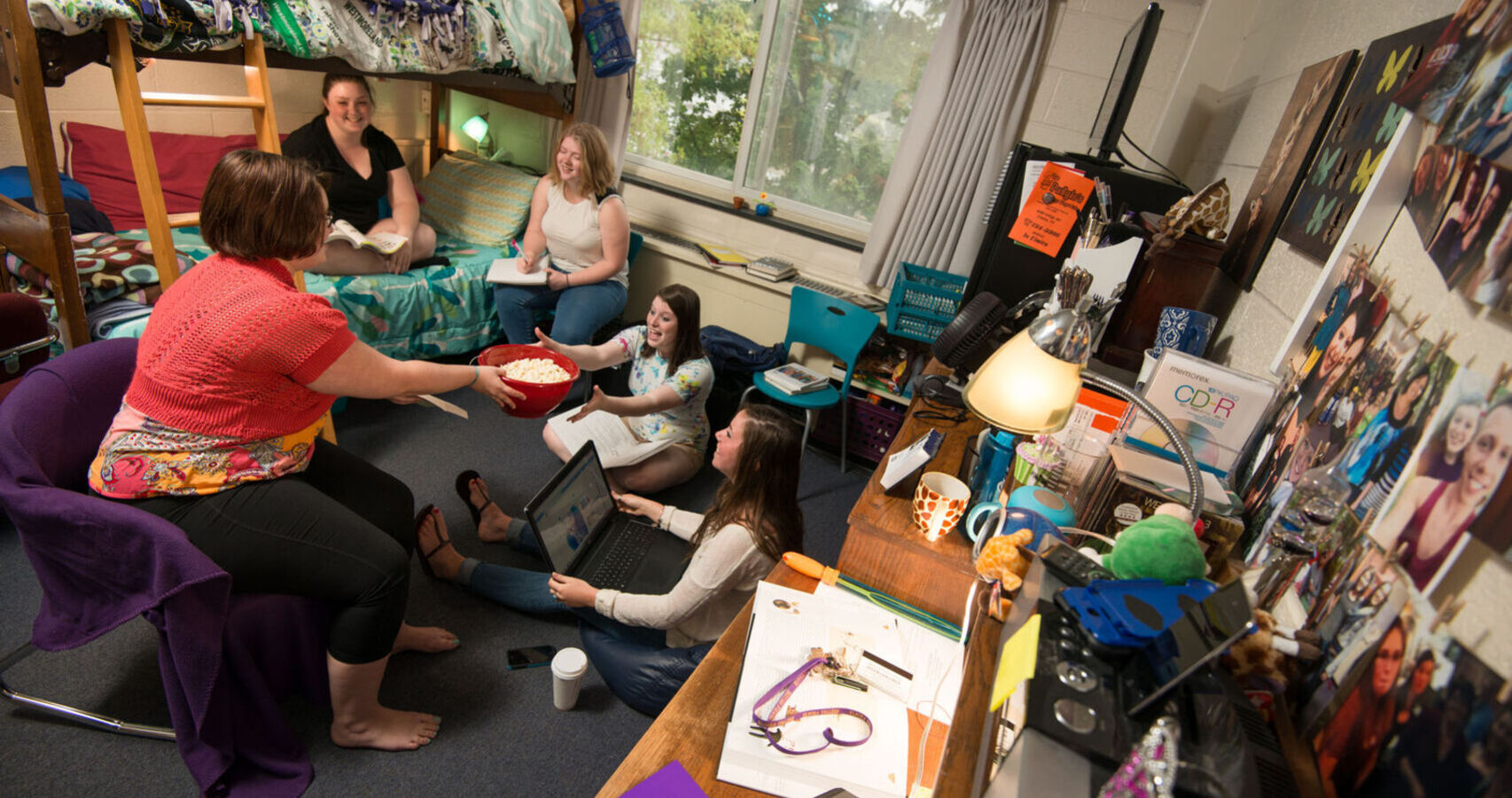 A group of students hang out in a dorm room