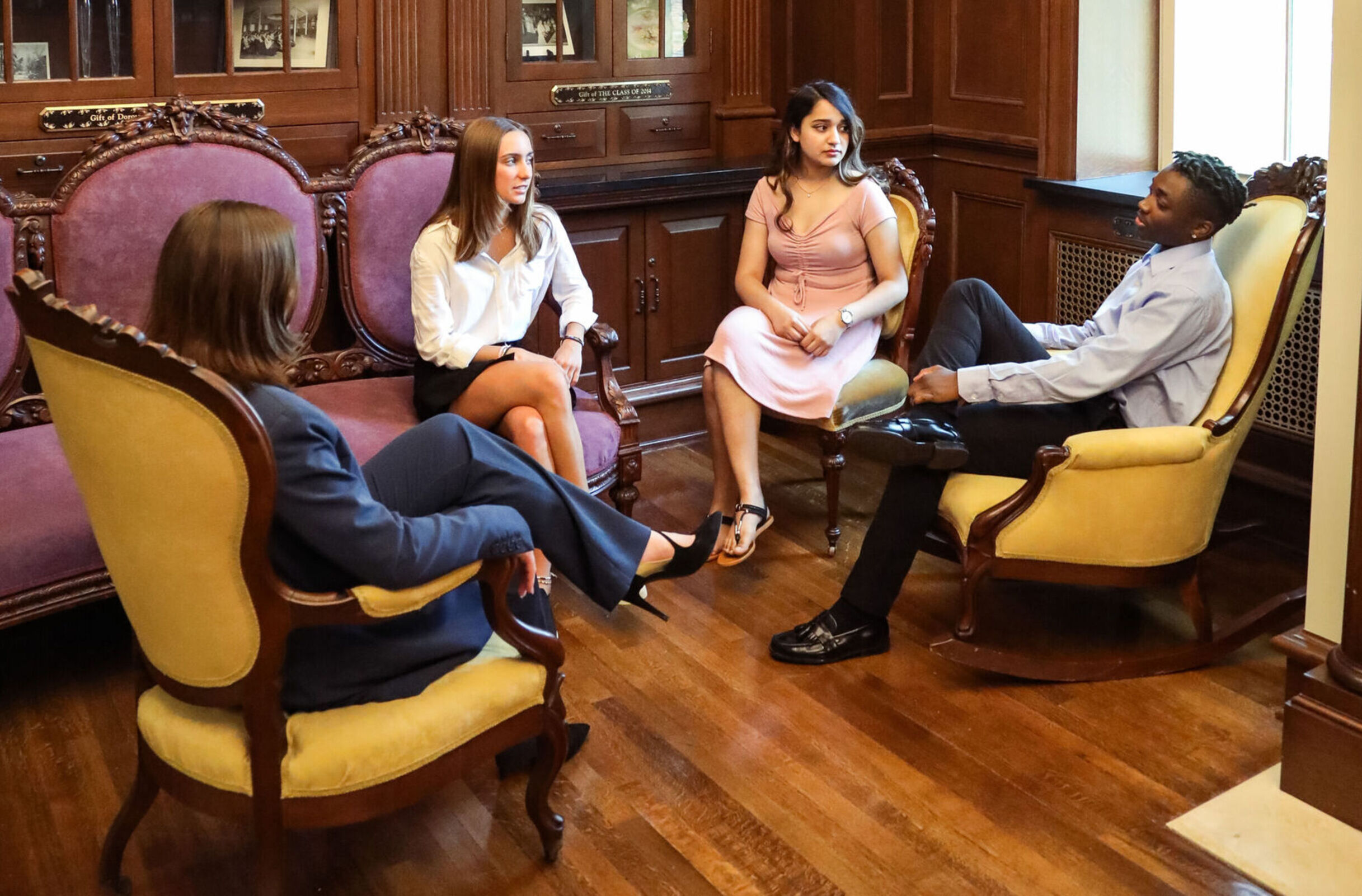 Four business students meet in a comfortable lounge area