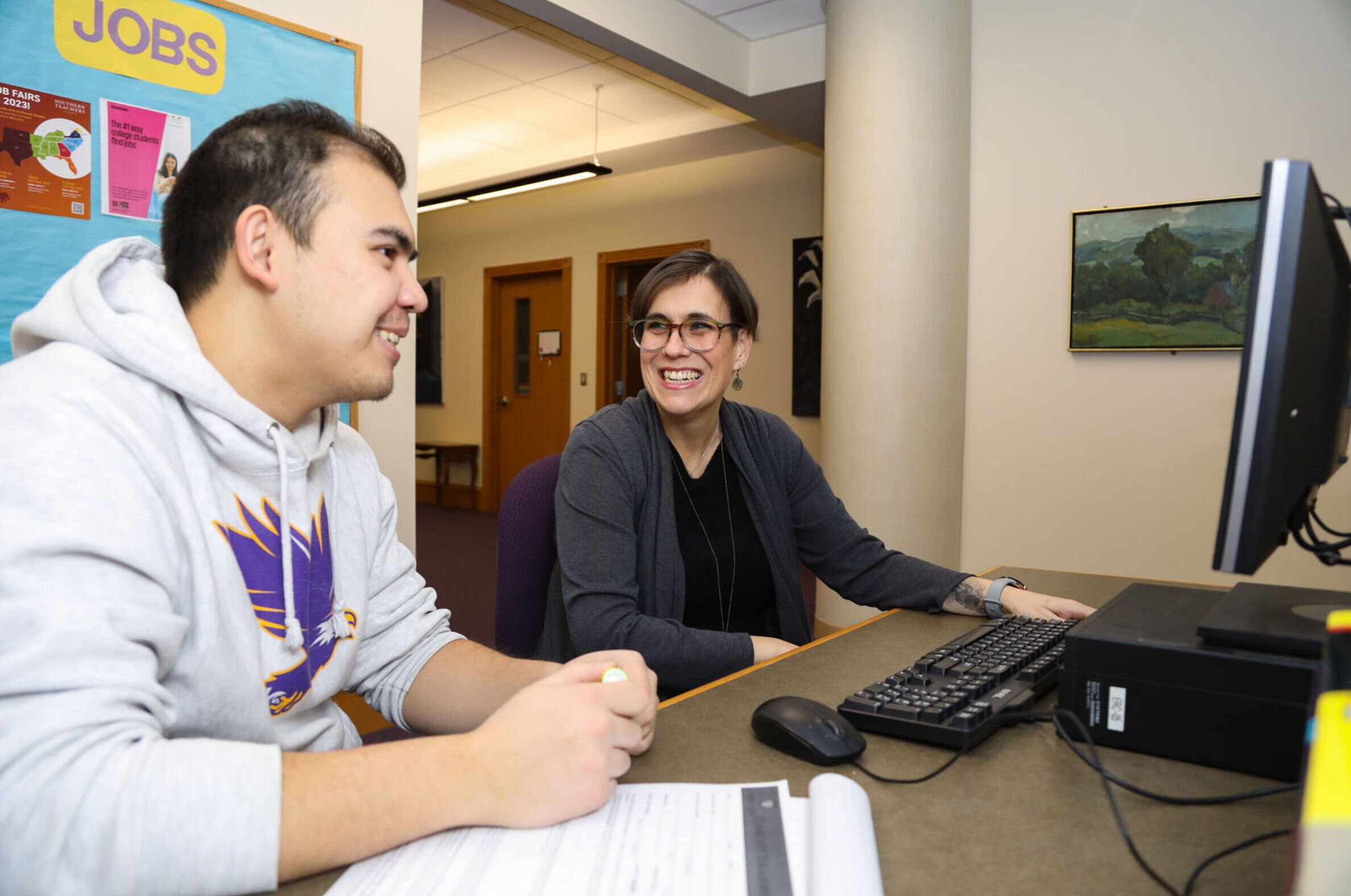 A career counselor helps a student prepare for his future