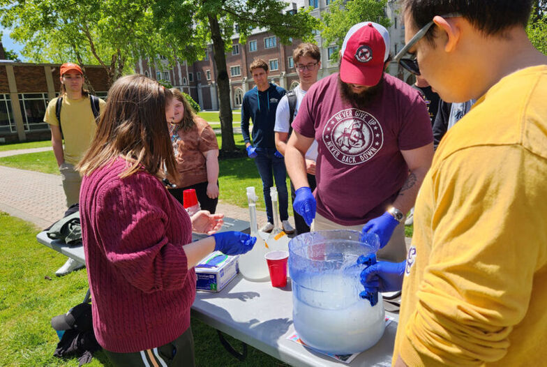Chemistry Club members mix a batch of slime for students to throw at faculty