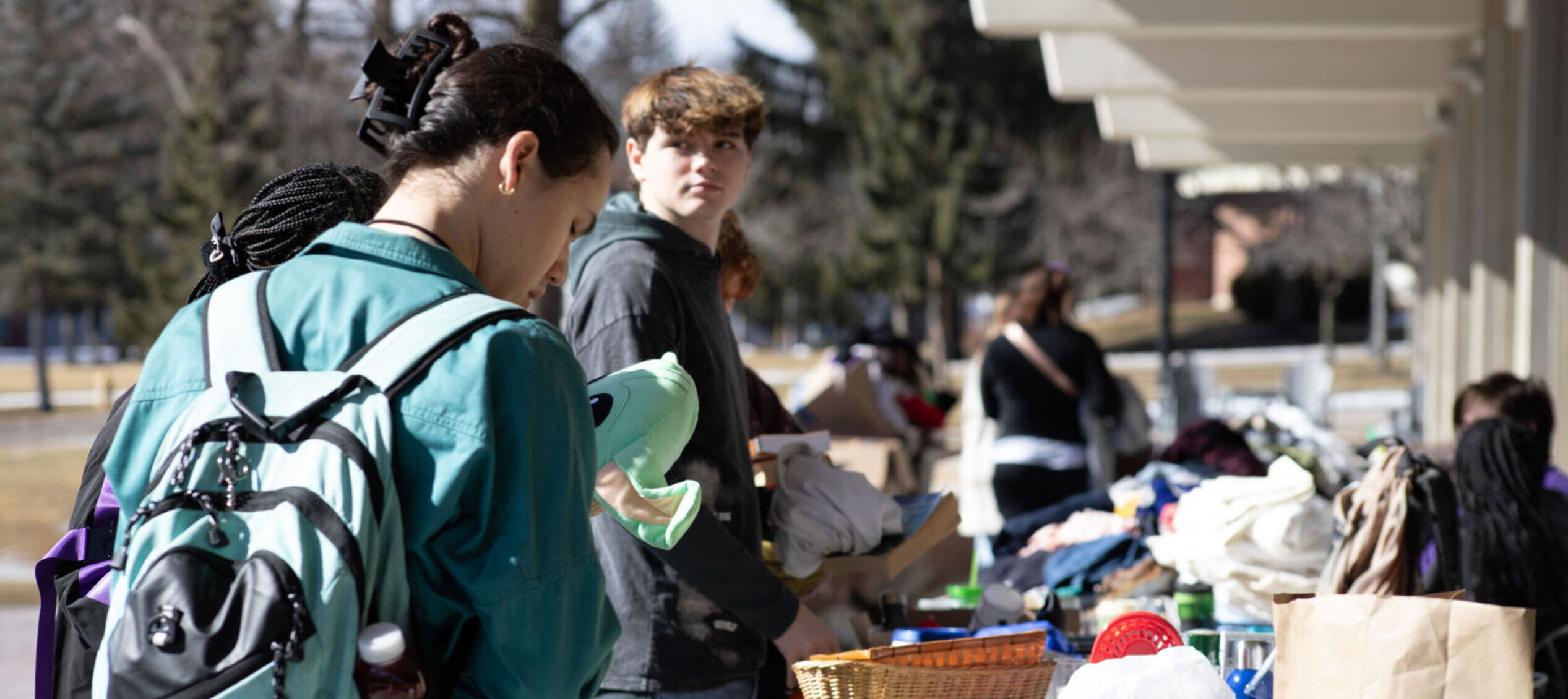 Students look through donated household items outside of the Elmira College Campus Center