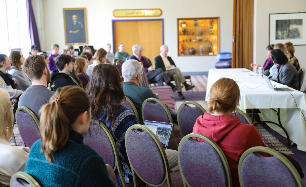 Students and other attendees listen to a Climate Teach-In panel discussion