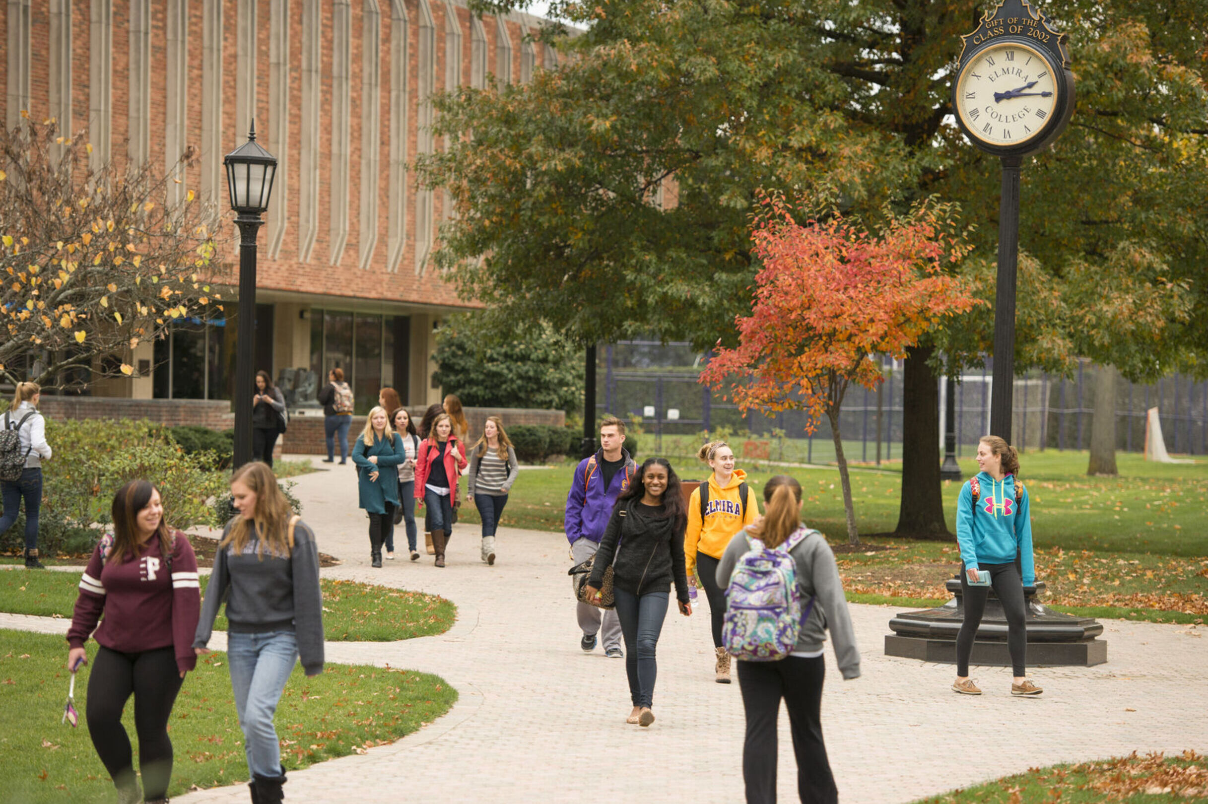 Students walk on campus during the fall