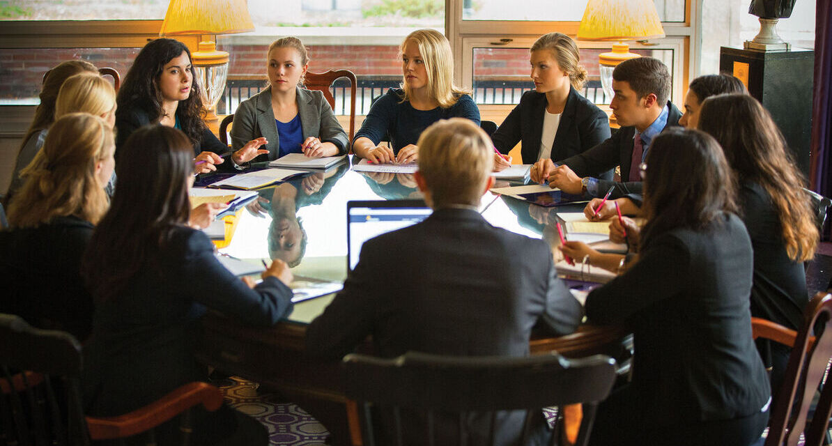 Students participate in a round table meeting