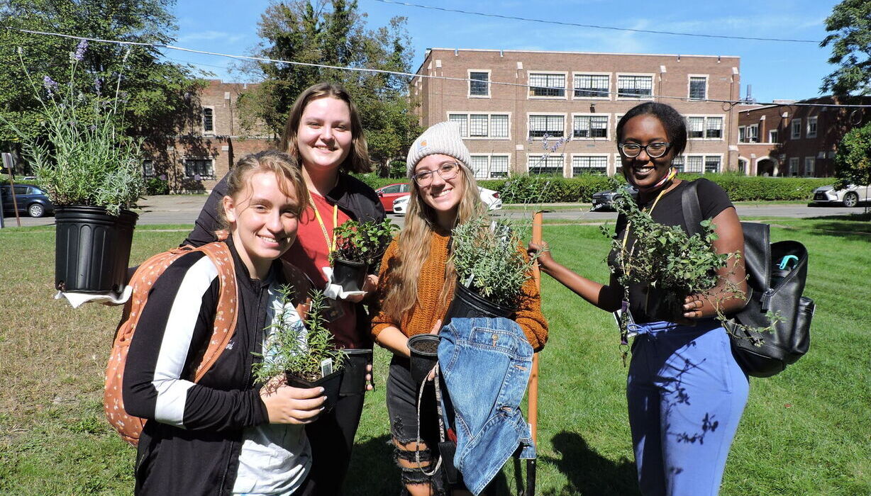 First-Year Service students are pictured with plants