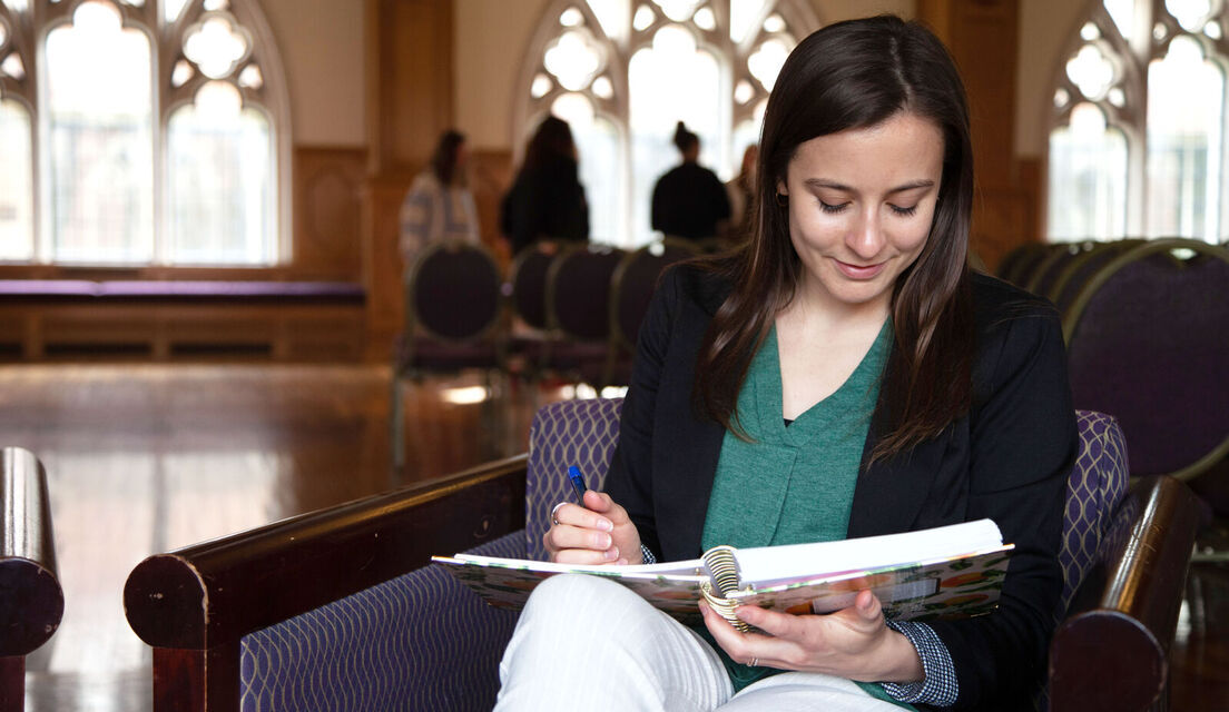 A graduate student reads in a study