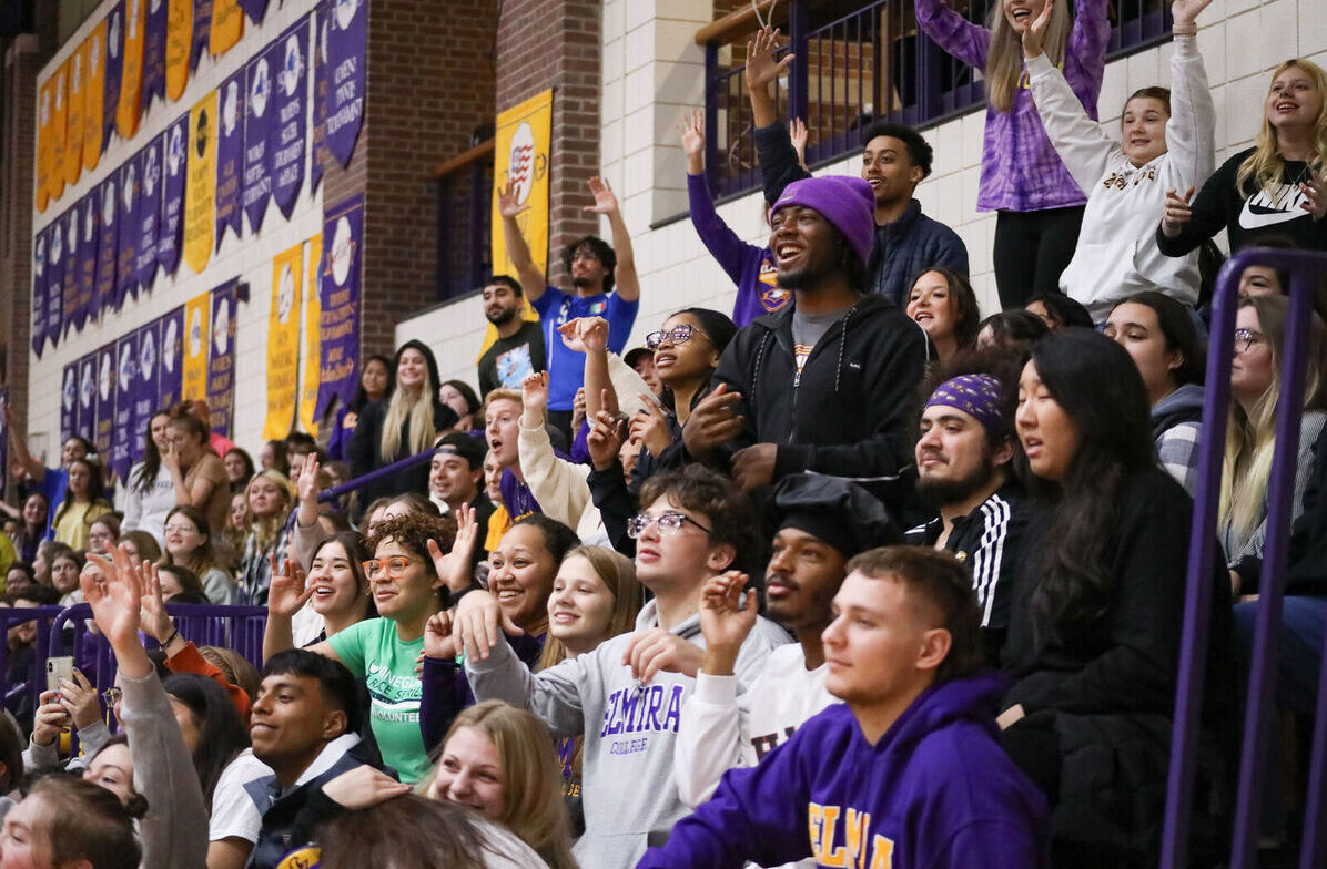Students fill the bleachers as they cheer during Hoops Hysteria