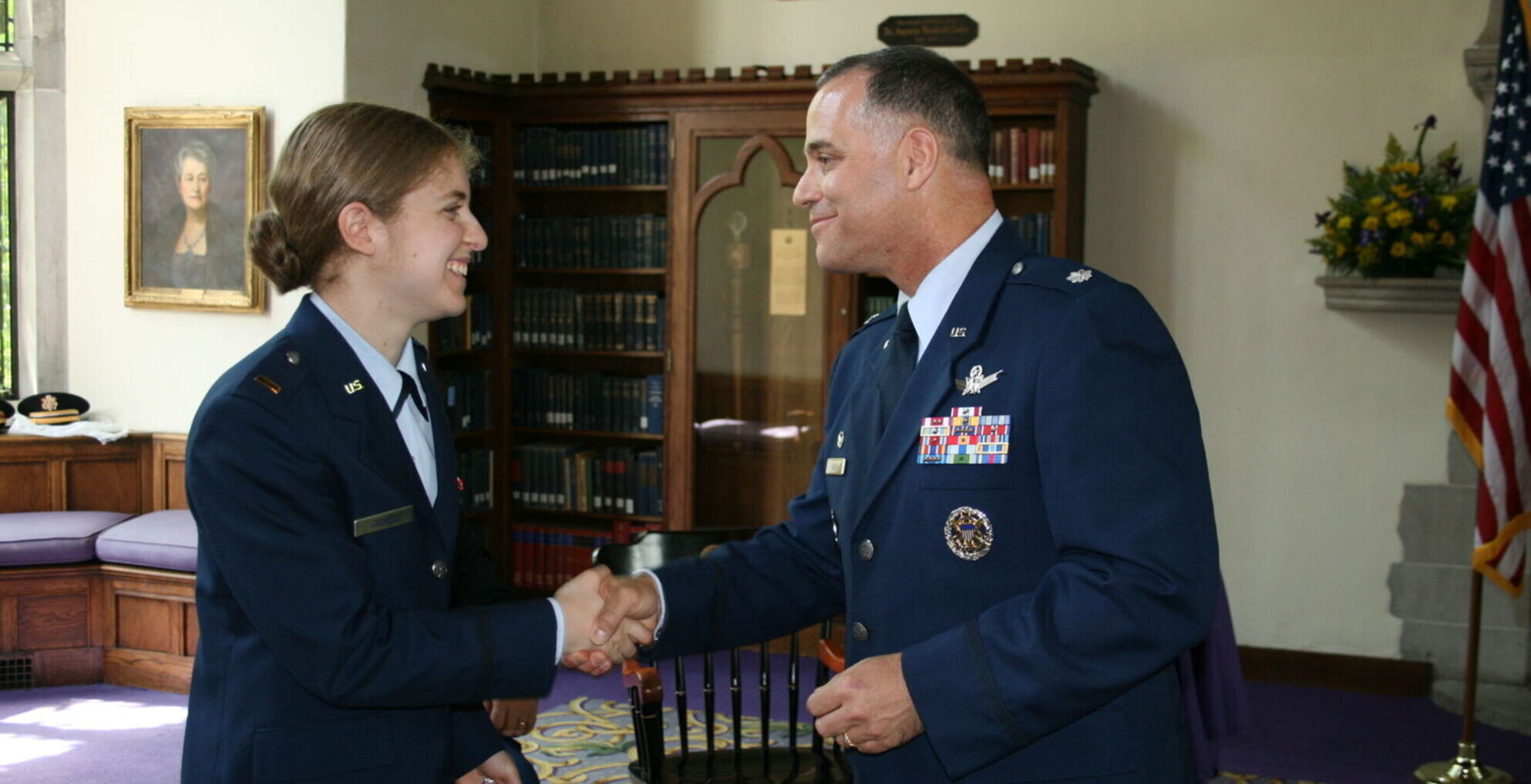 Graduate is congratulated by a superior officer. 