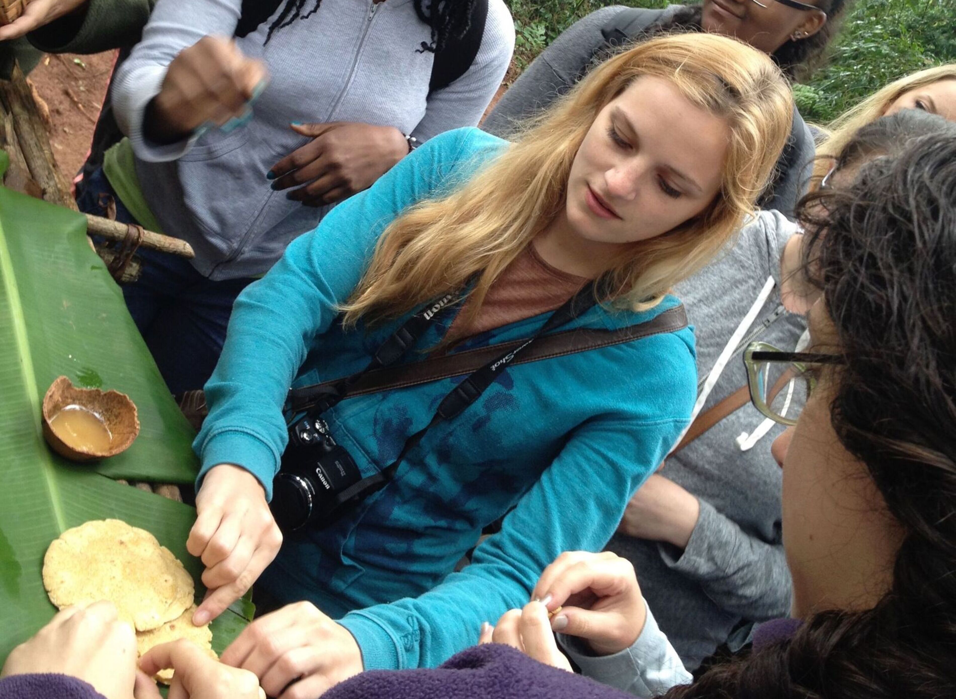 A student exams plant biology in a wooded area