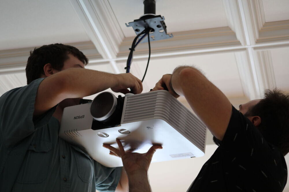 IT staff works to install new equipment. 