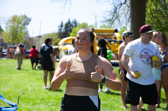 A student gives a thumbs up during May Days
