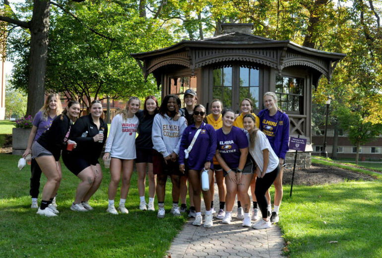 A group of female students smile in front of the Mark Twain Study