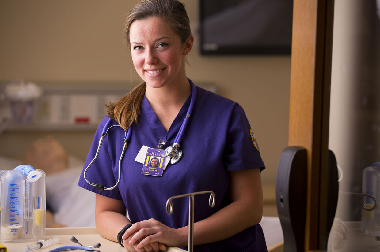 A Nursing student poses in a simulation laboratory