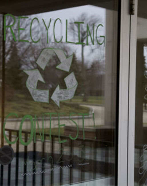 Recycling Contest is painted on a glass door, promoting a recycling contest between residence halls 