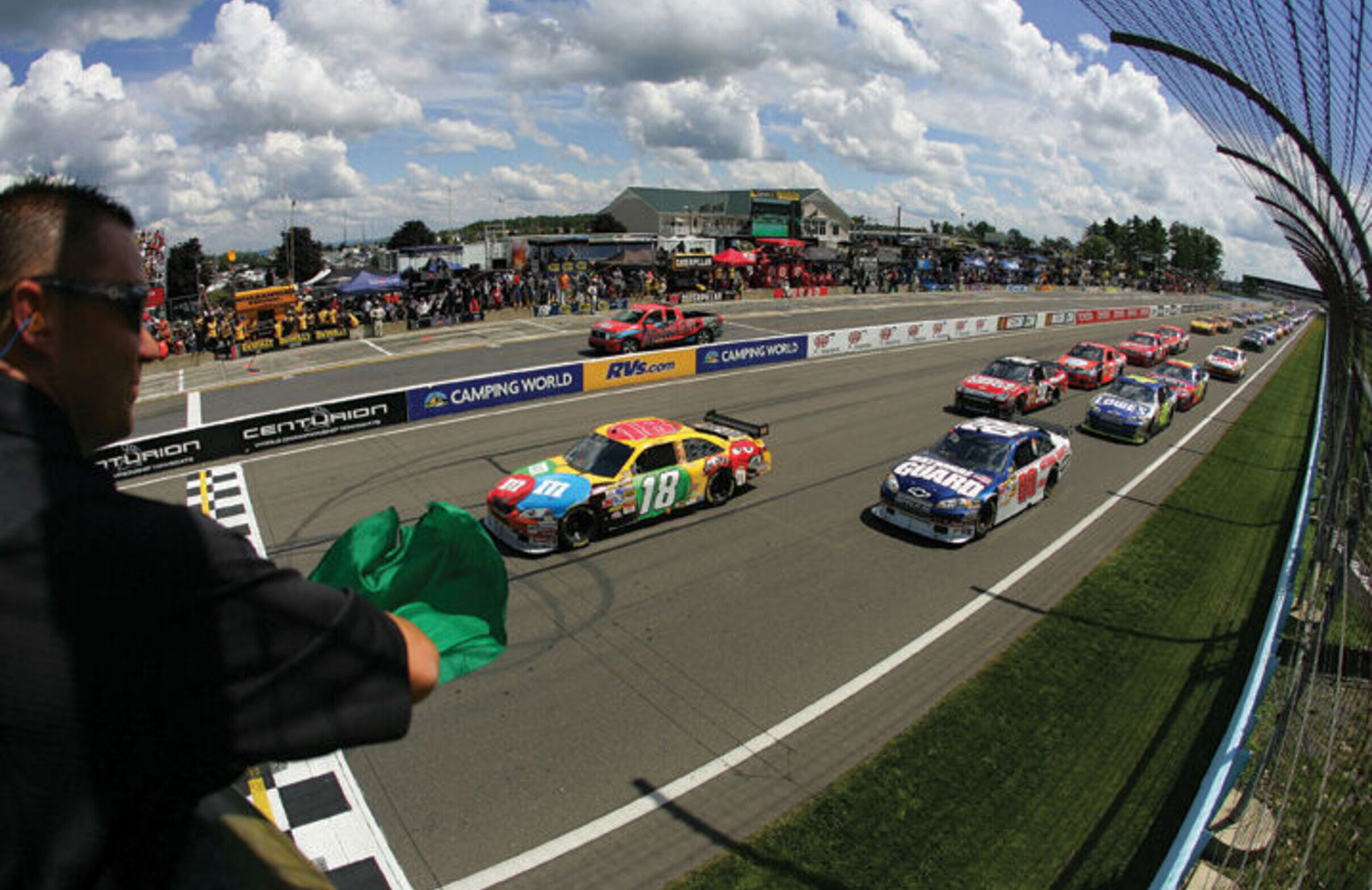 Cars race around the Watkins Glen Motor Speedway track