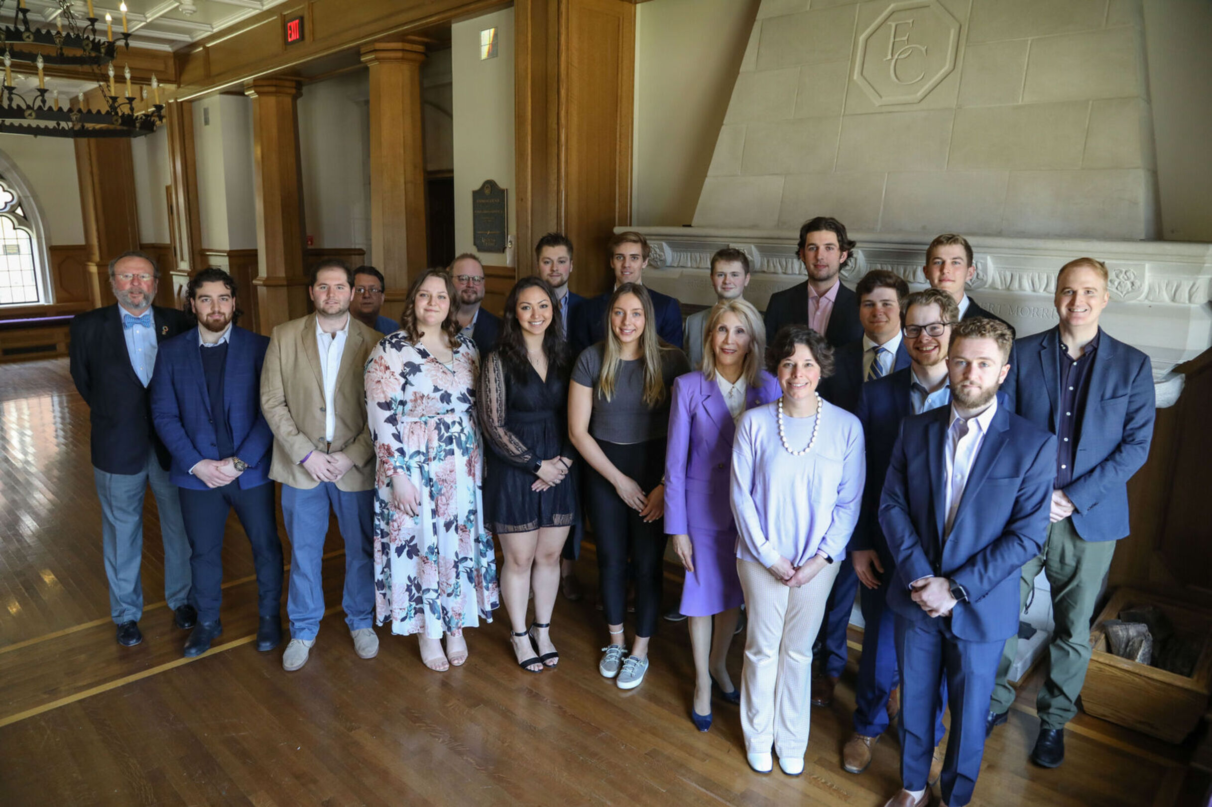 Students inducted into the Sigma Beta Delta Honor Society for Business stand with faculty during the 2023 induction ceremony