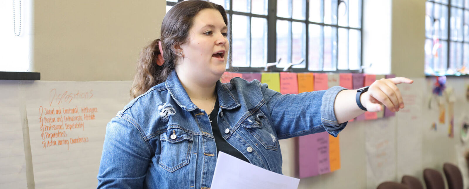 A female education major calls on someone during a practice lesson